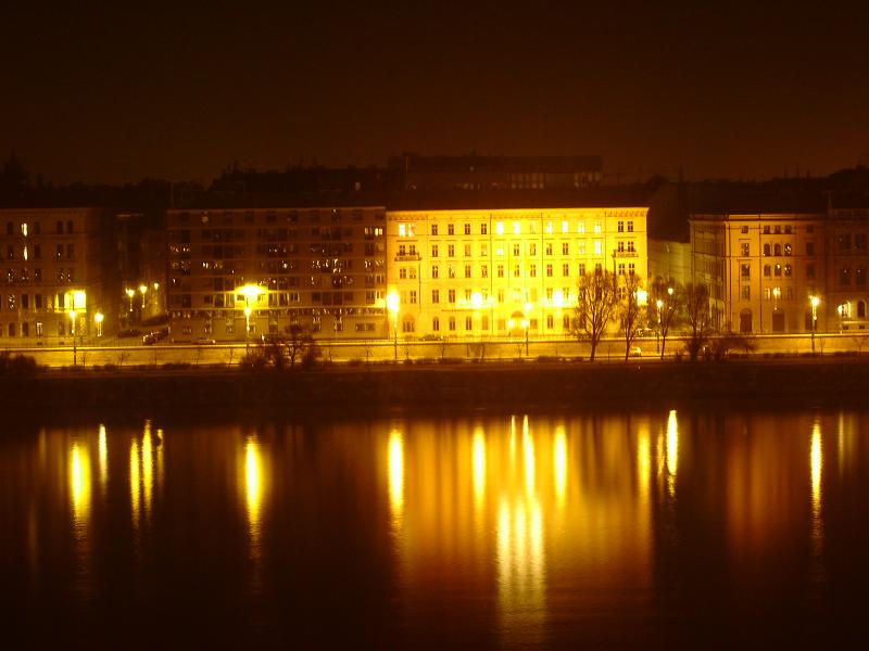 illuminated buildings along the waterfront of a city at night