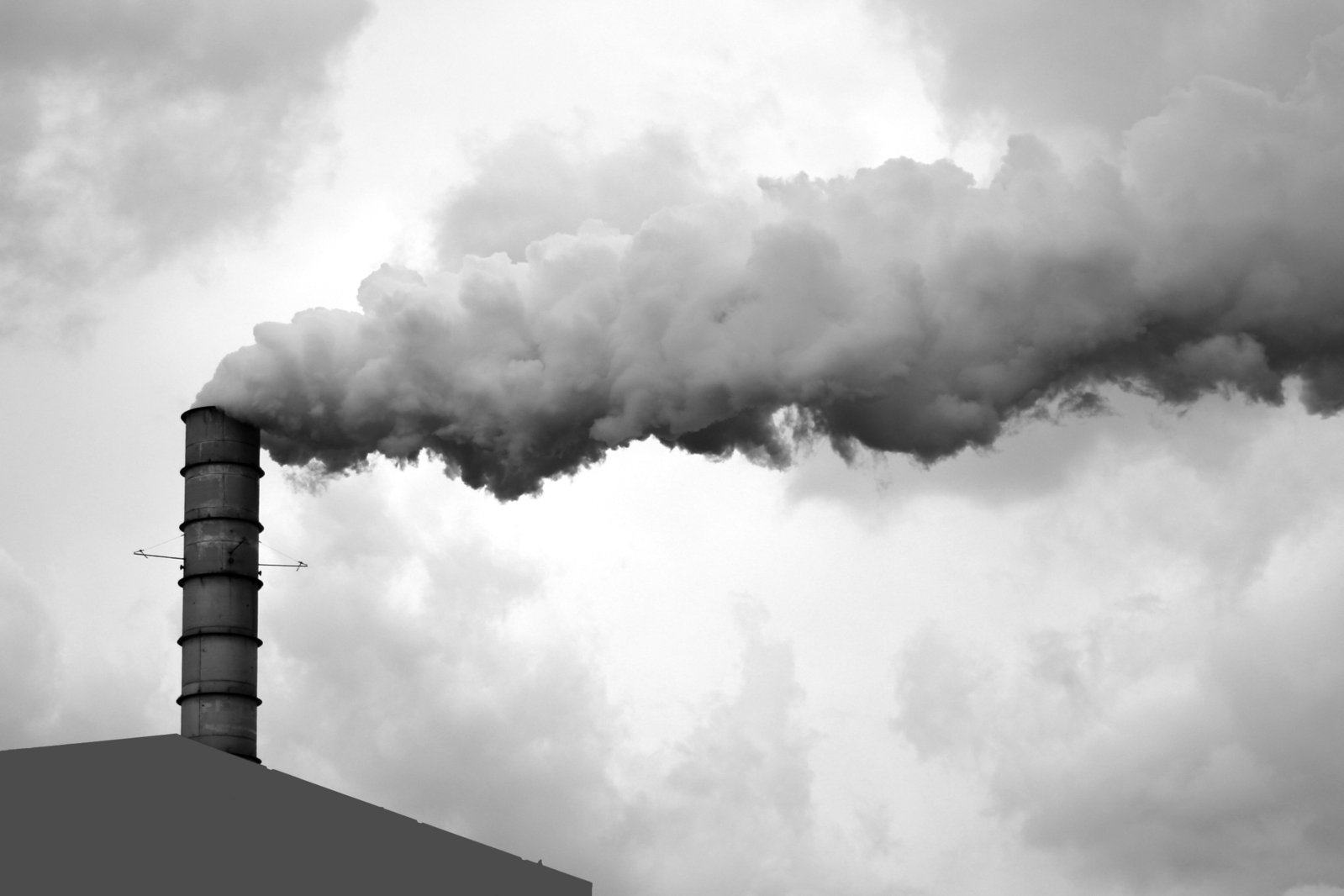 smoke is coming out of a chimney on a building