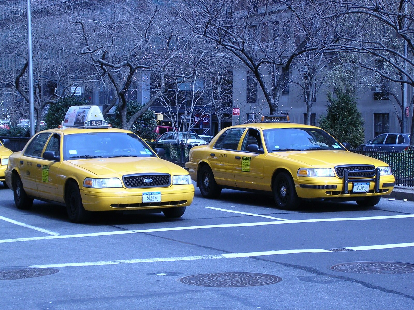 three taxi cabs are shown with the driver