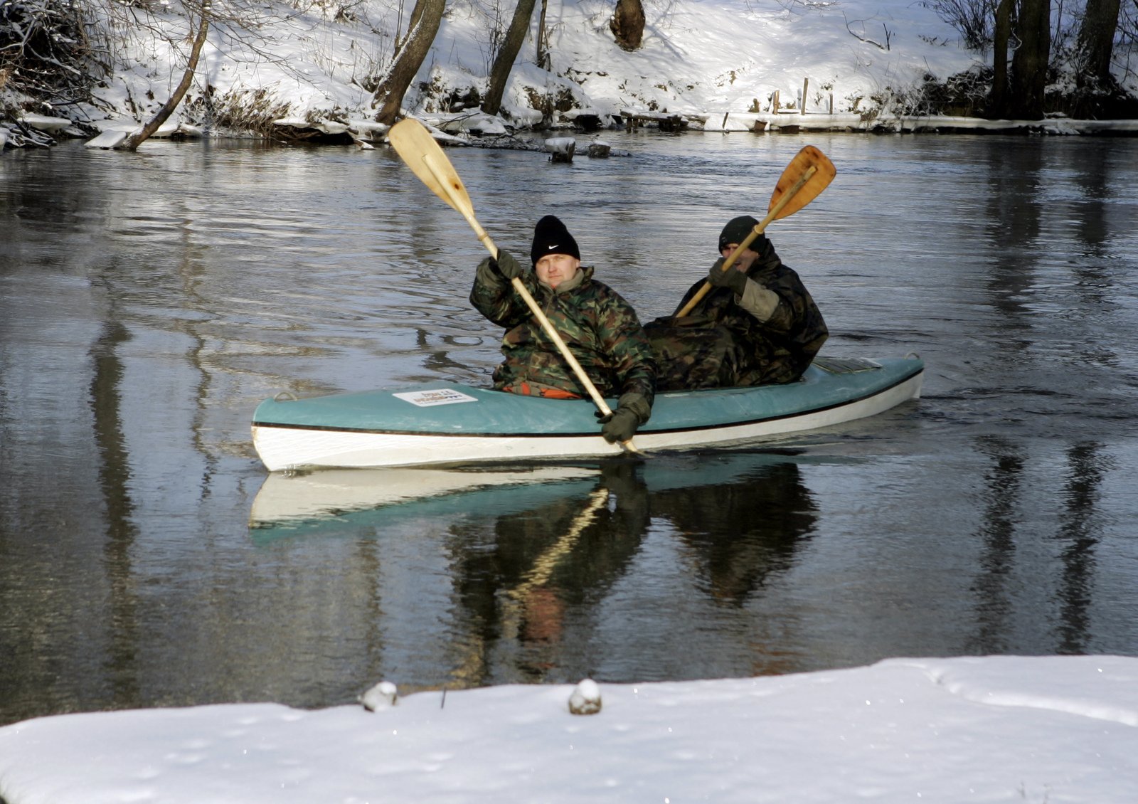 two people on a paddle boat paddling through water