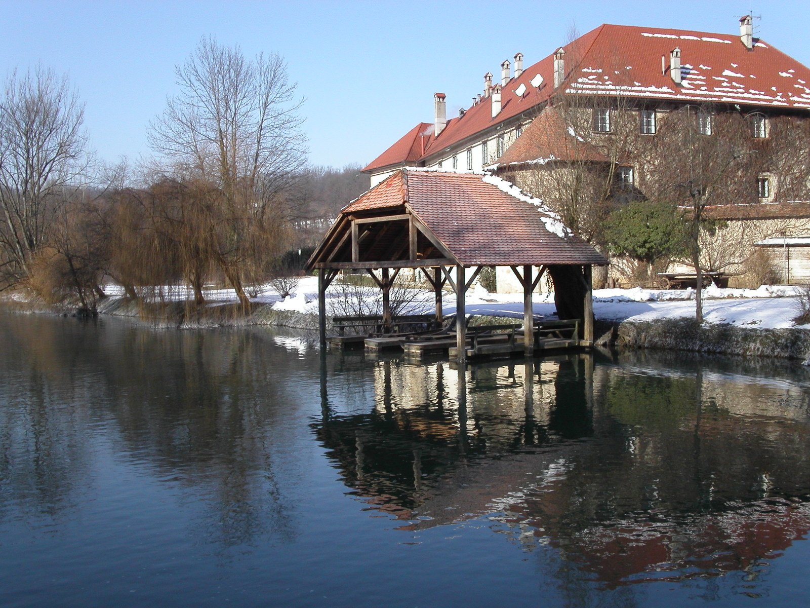 a gazebo and a building next to a body of water