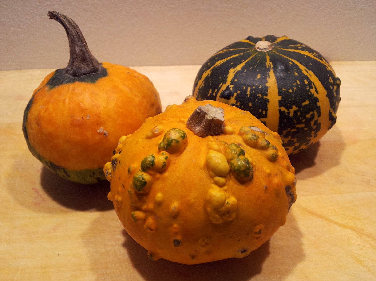 three pumpkins that are on a table