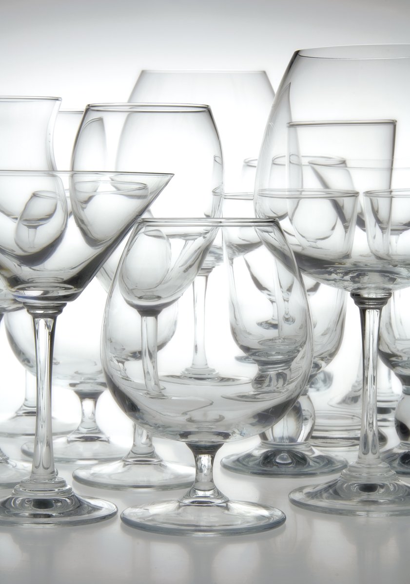 various wine glasses sitting side by side on a table