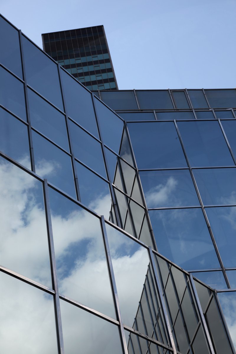 an exterior view of a building with mirrored windows