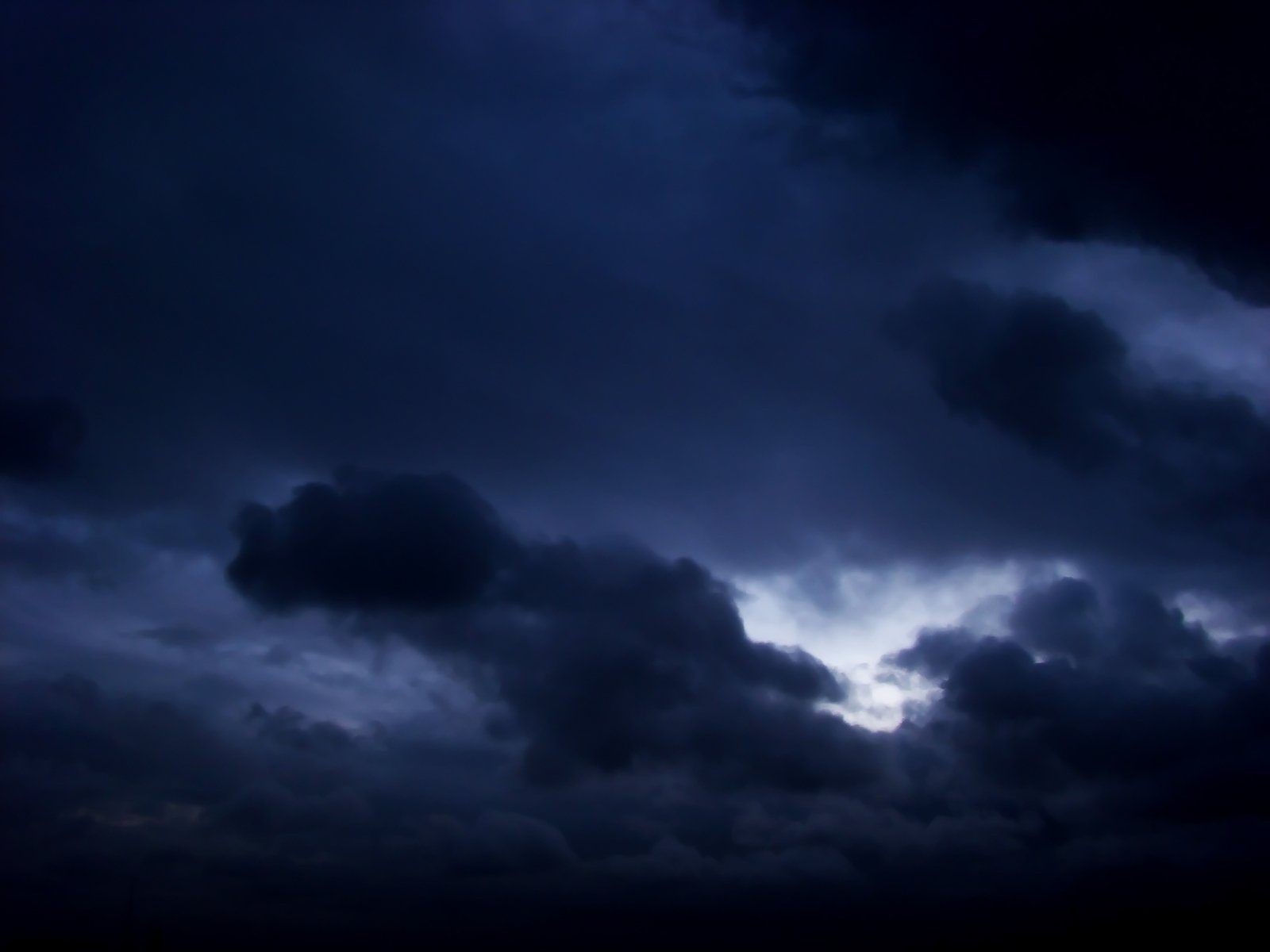 dark clouds with some white and gray ones