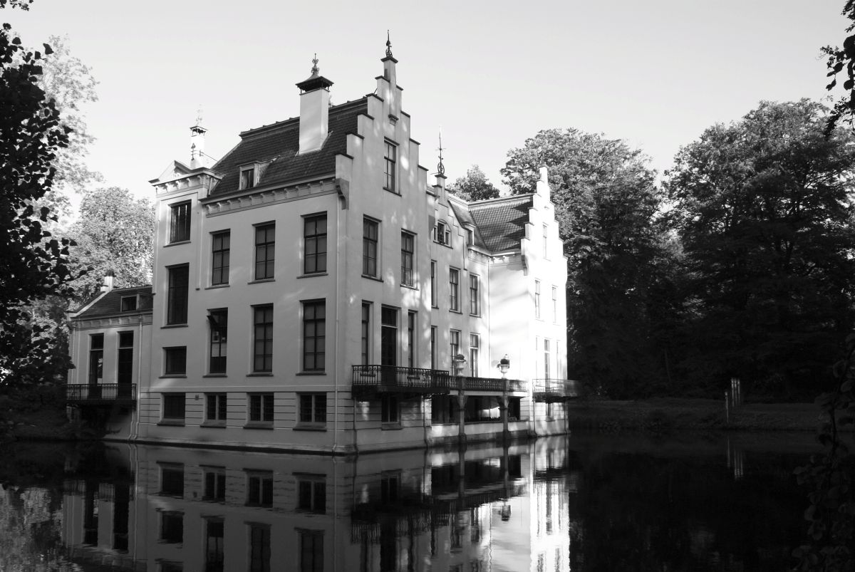 an old building is reflected in water