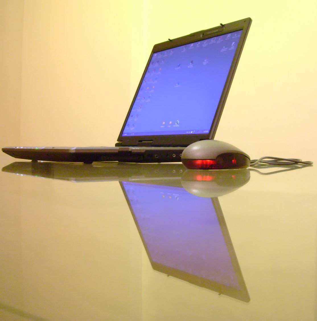 a laptop computer with the screen lit up with a mouse