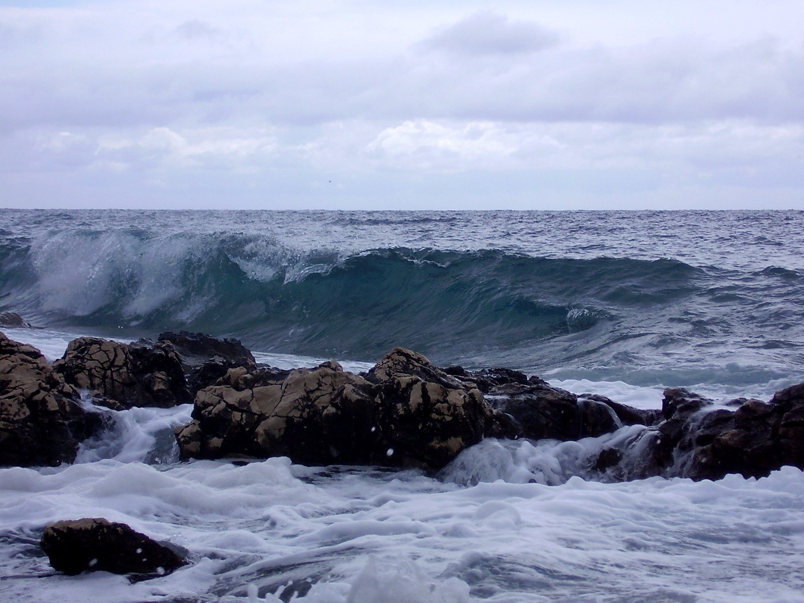 water crashing over rocks in the ocean