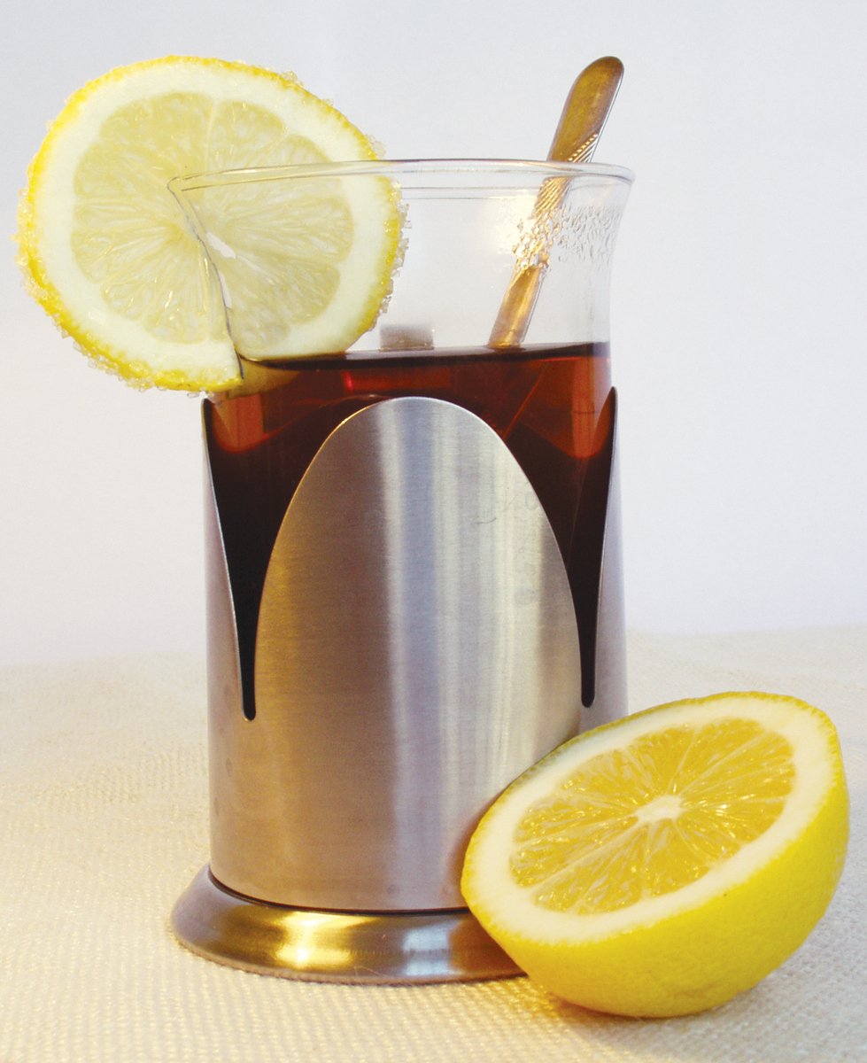 an iced coffee cup with lemons and a spoon