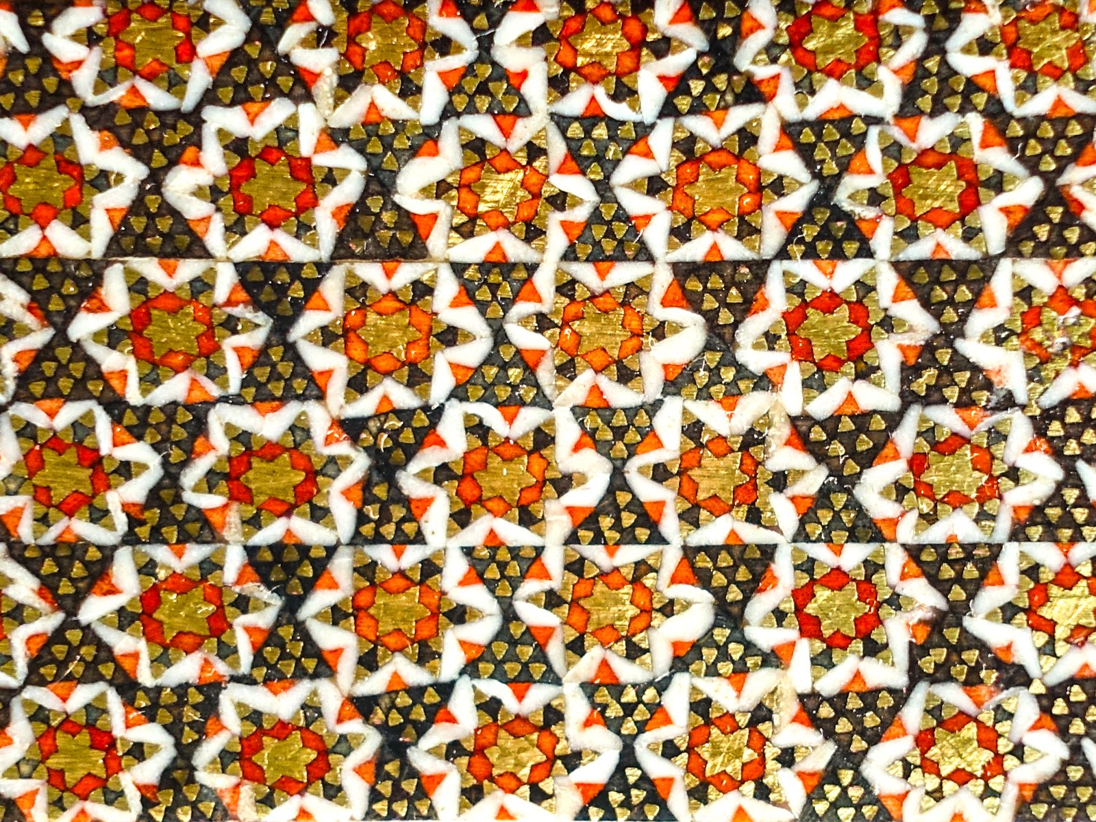 a very decorative piece of fabric with gold, white and orange flowers