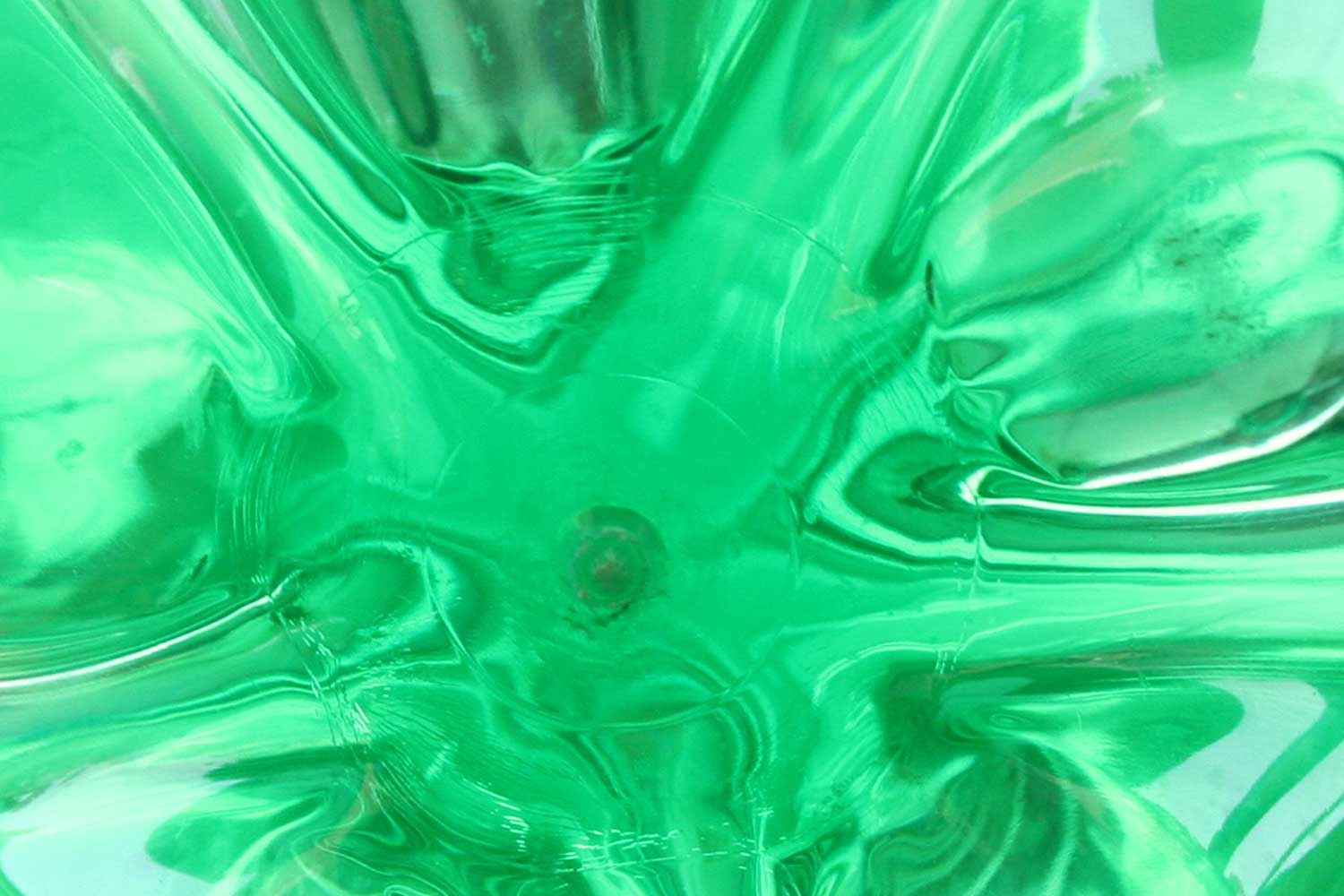a po of green liquid on a blue surface