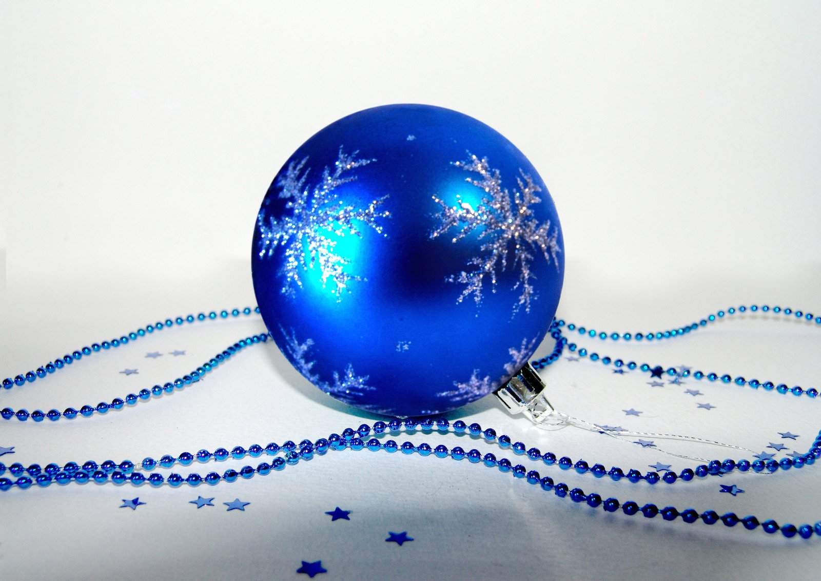 a blue ornament that is attached to beads