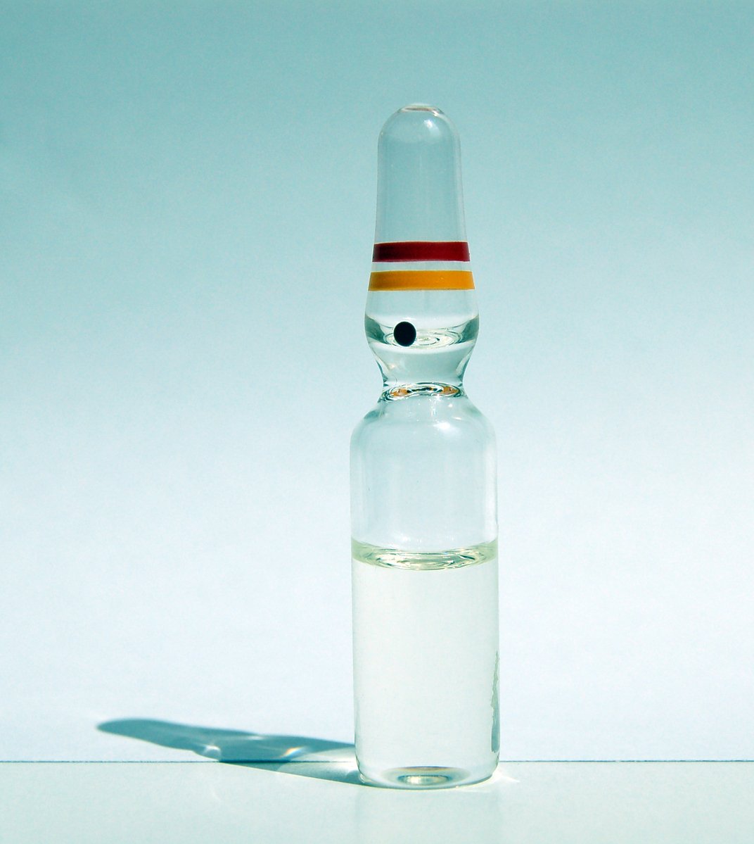 an empty bottle filled with white liquid