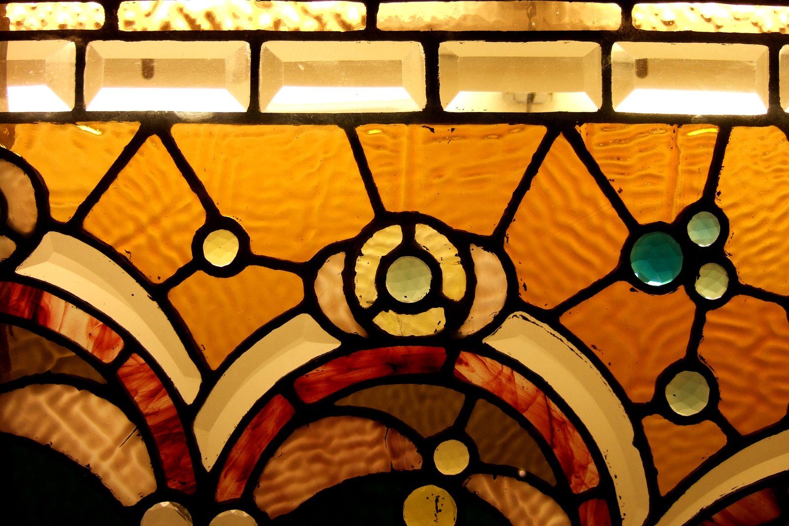 a large stained glass window with circles and spots on it