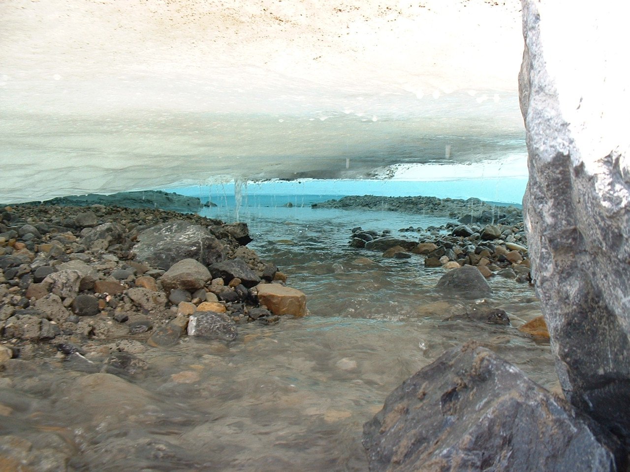 a lake surrounded by rocks and some water