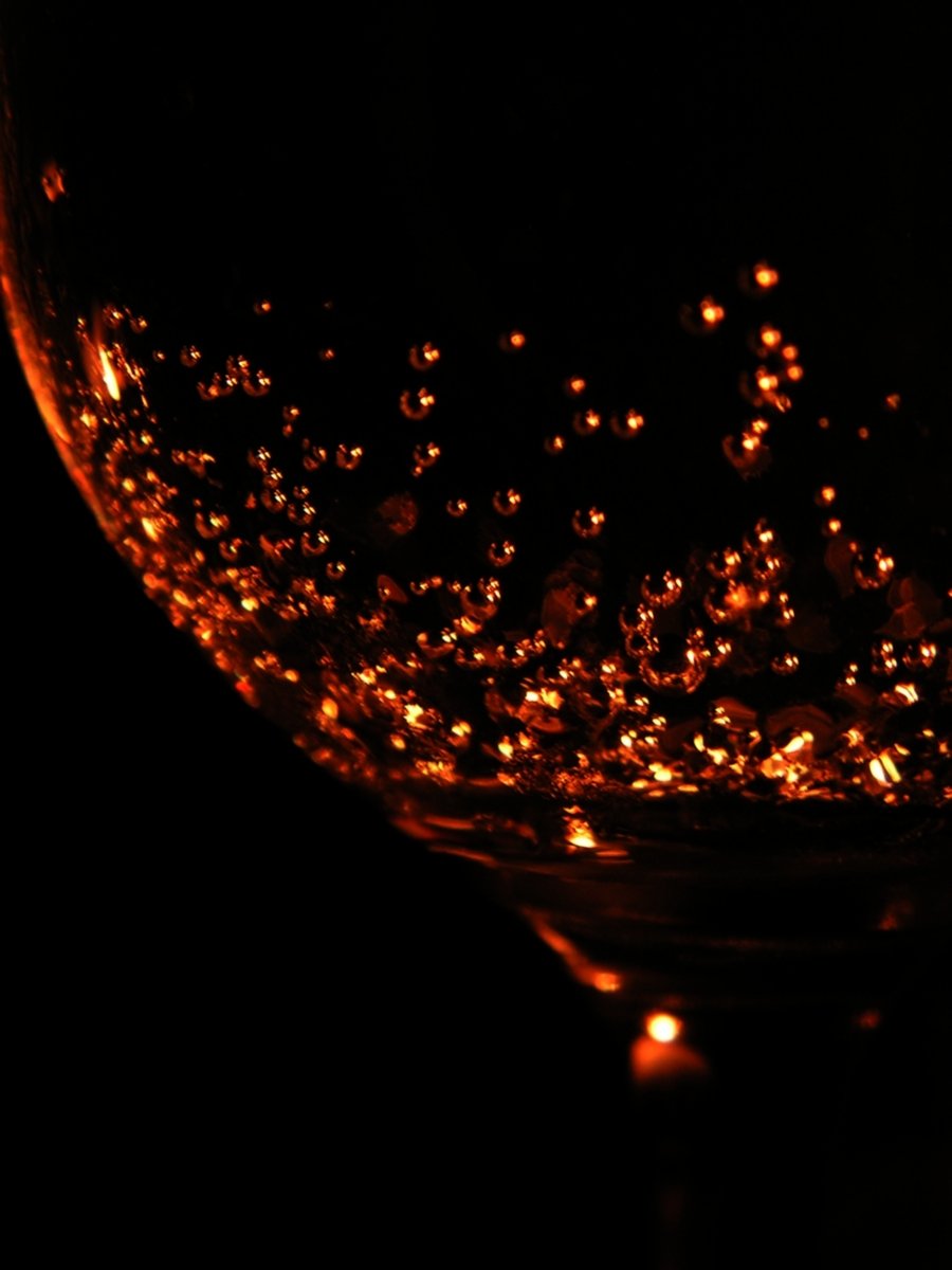 a glass full of water with some bubbles in it