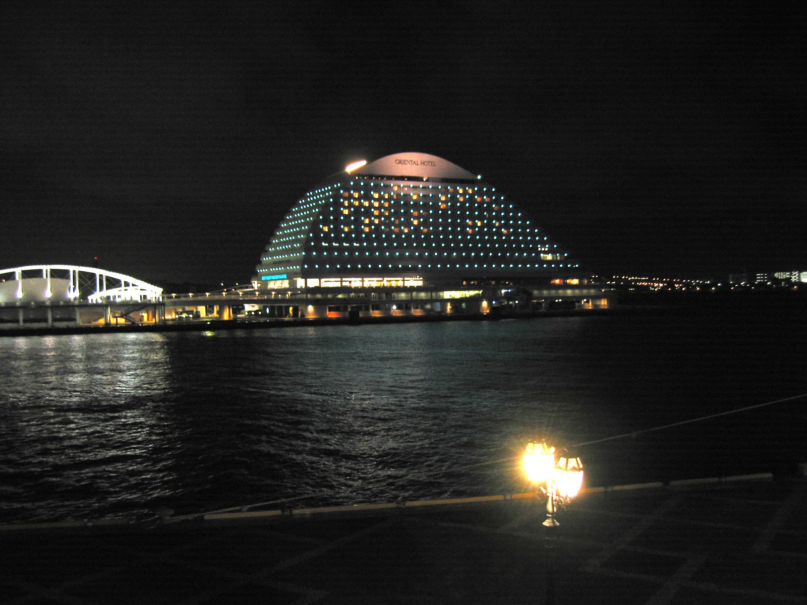 an artistic image of a large building by the water