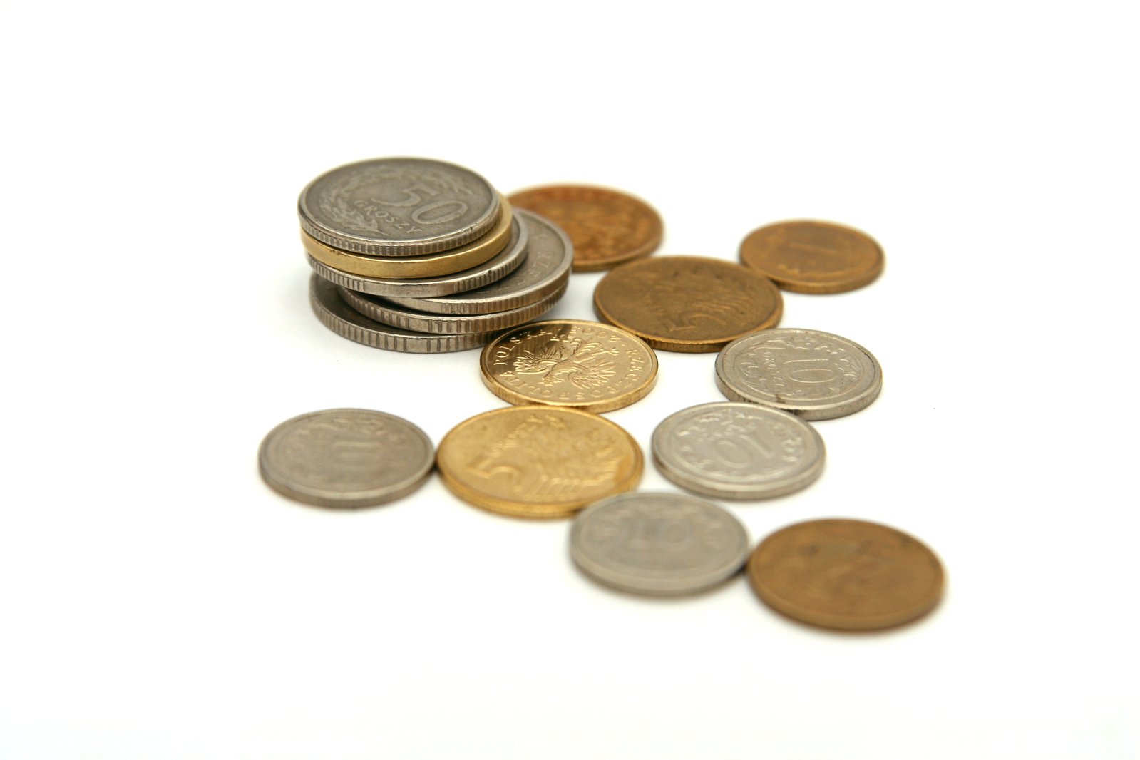 various british pound coins on a white background