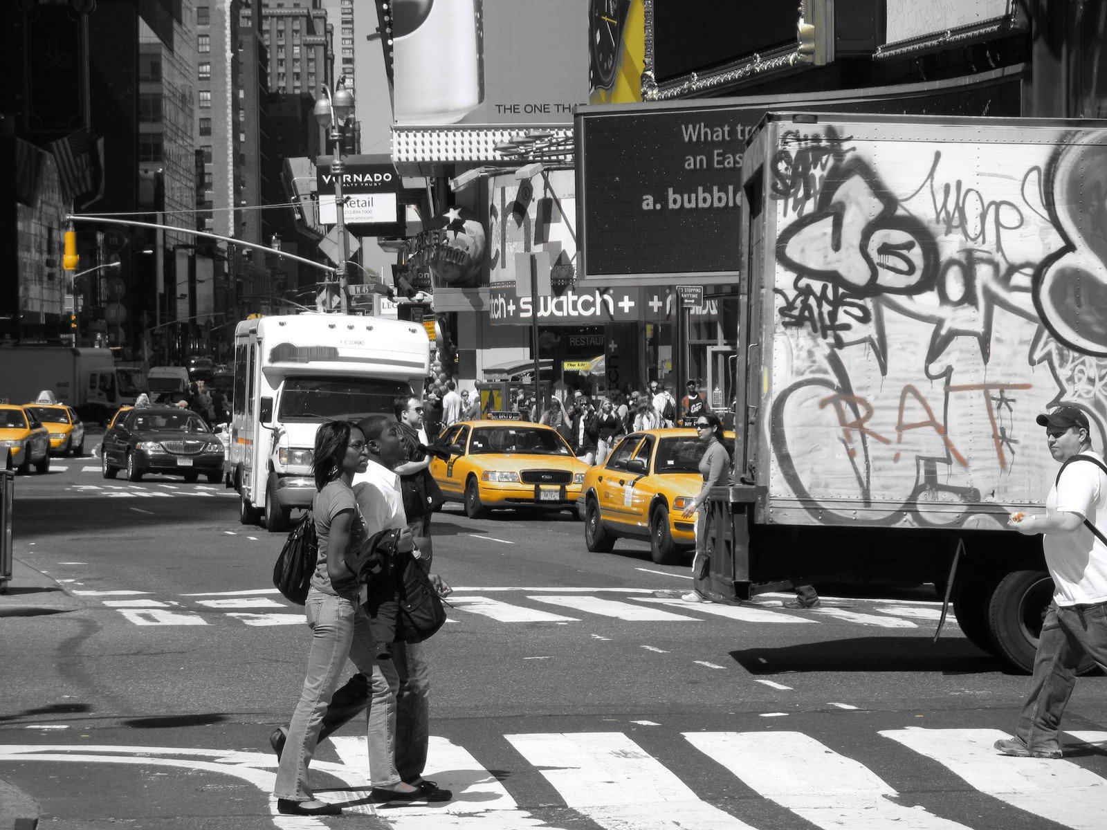 a street filled with vehicles and graffiti