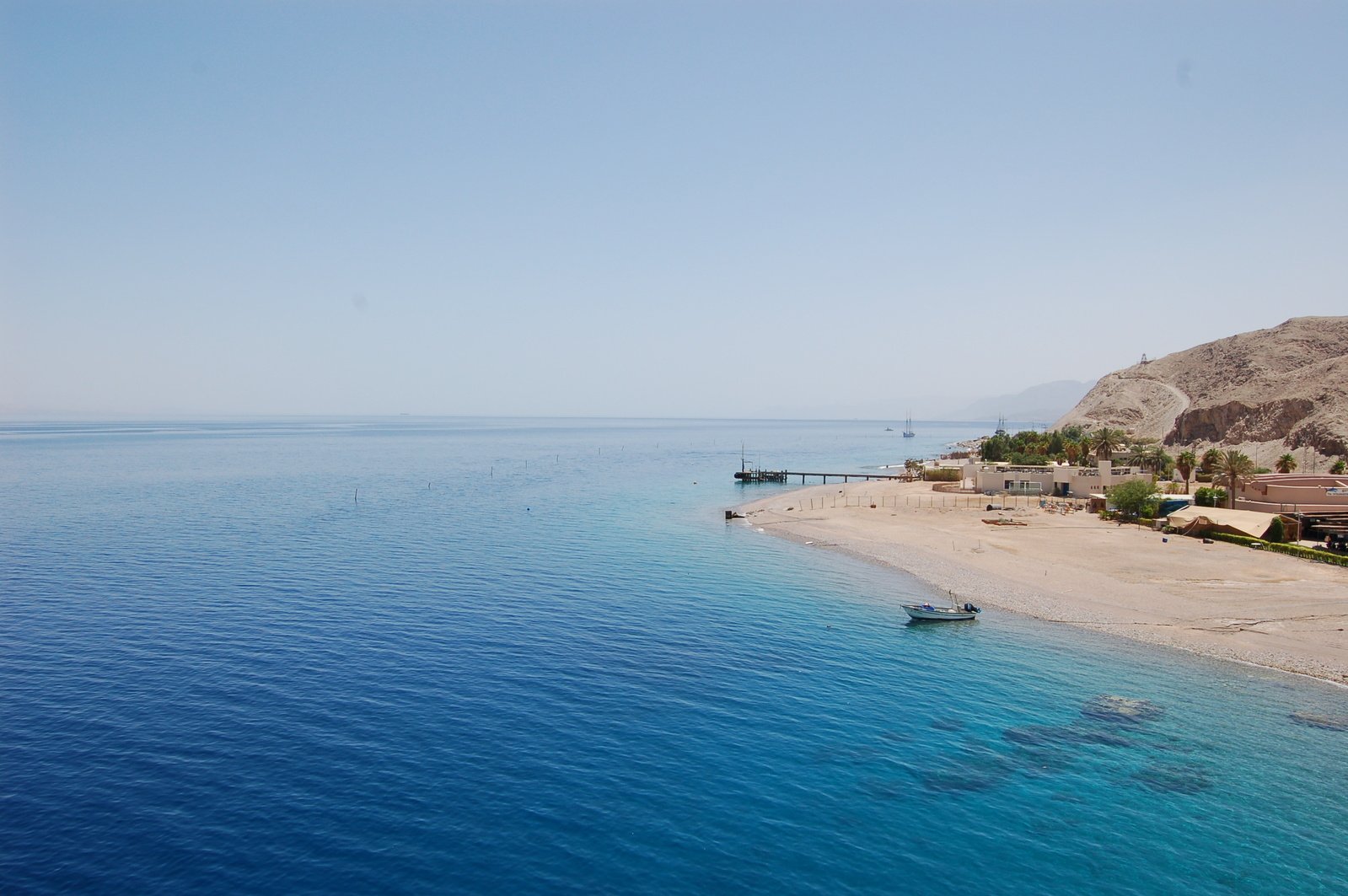 a beach sits on an island off the coast