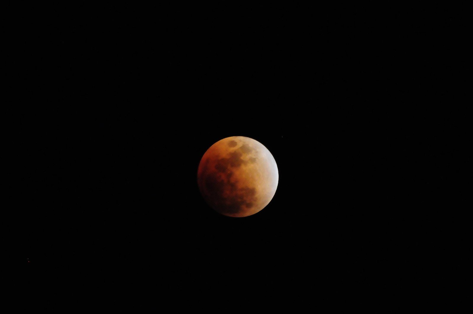 the eclipse of a red full moon with only visible