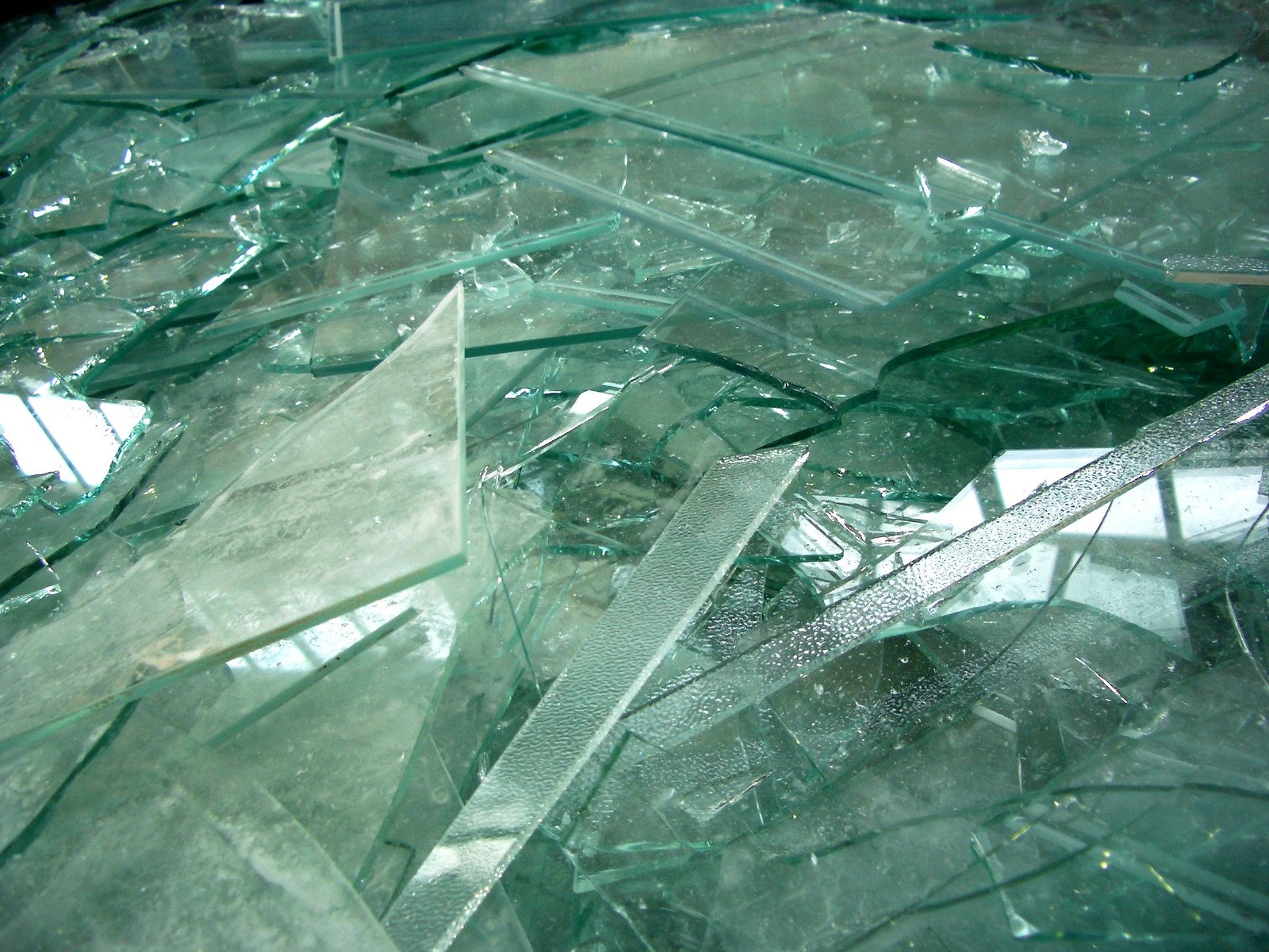 a bunch of broken glass objects lying on top of each other