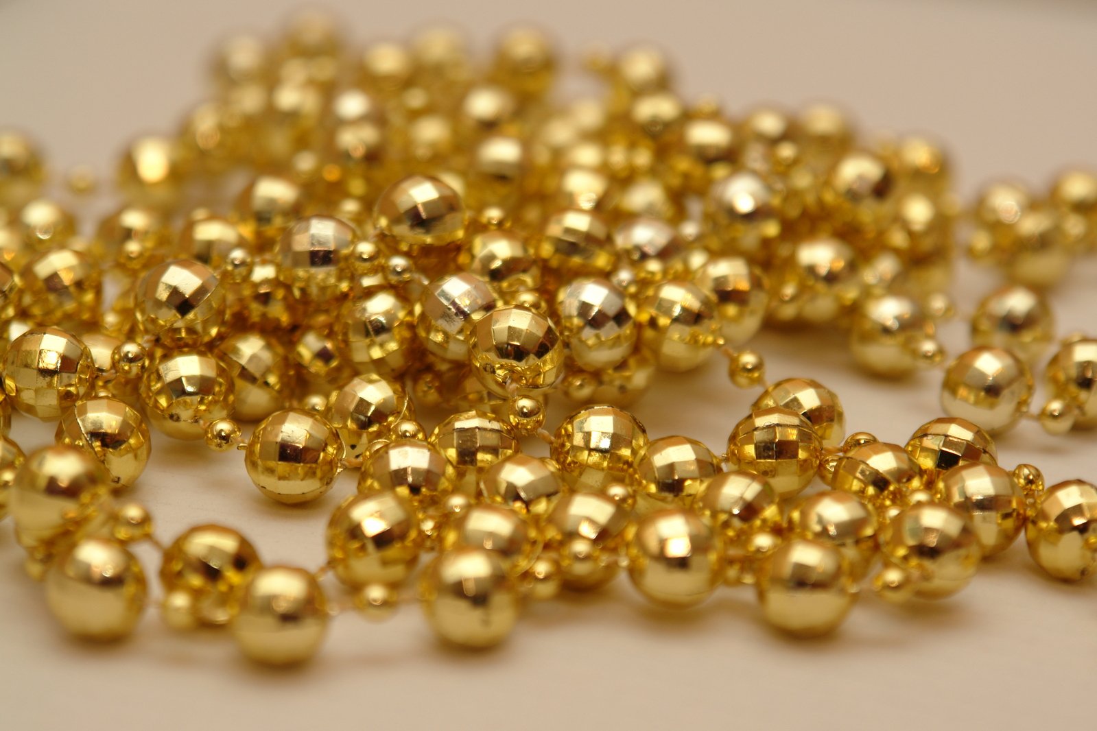 a bunch of gold colored beads laying on top of each other