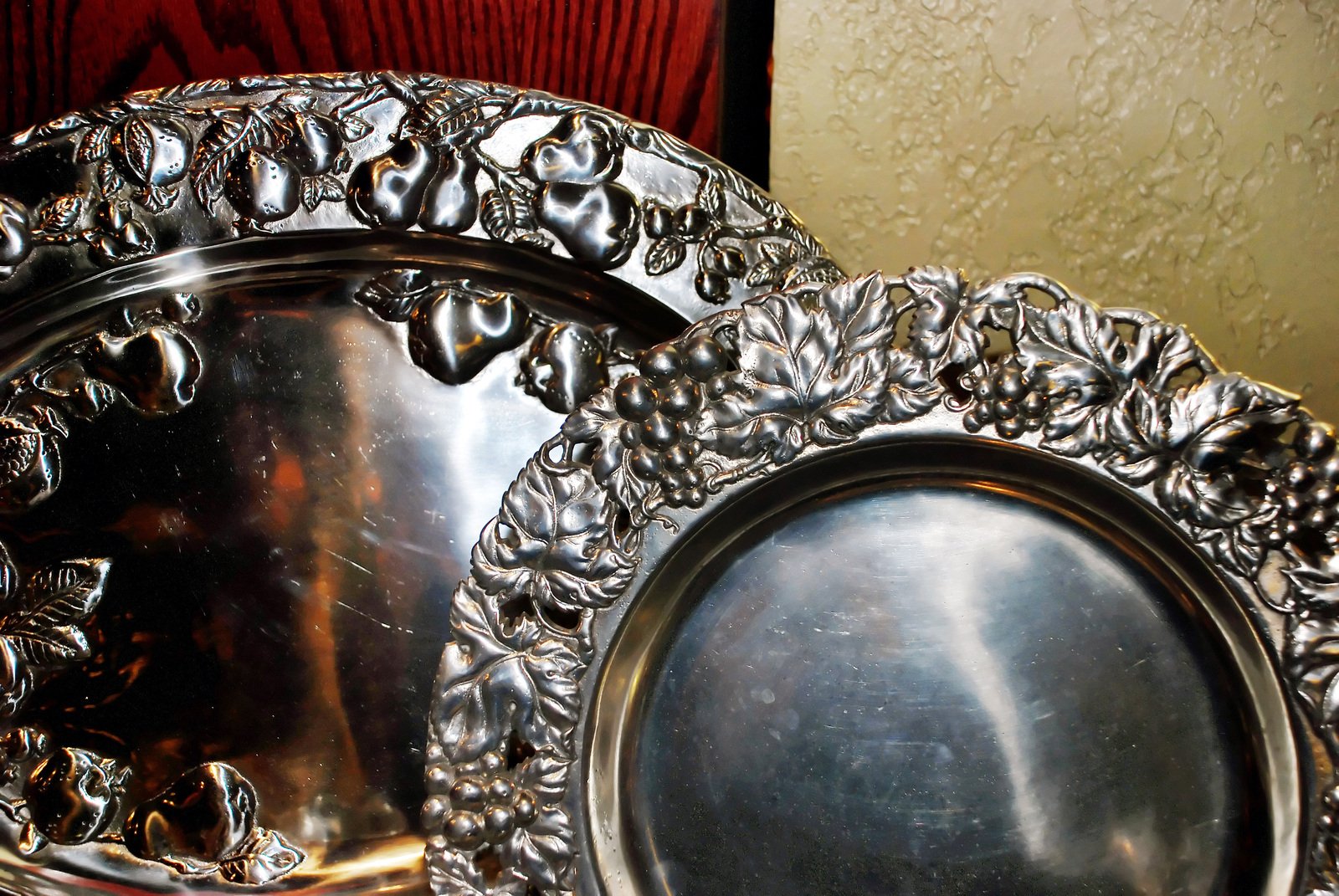two decorative metal plates sitting on a table