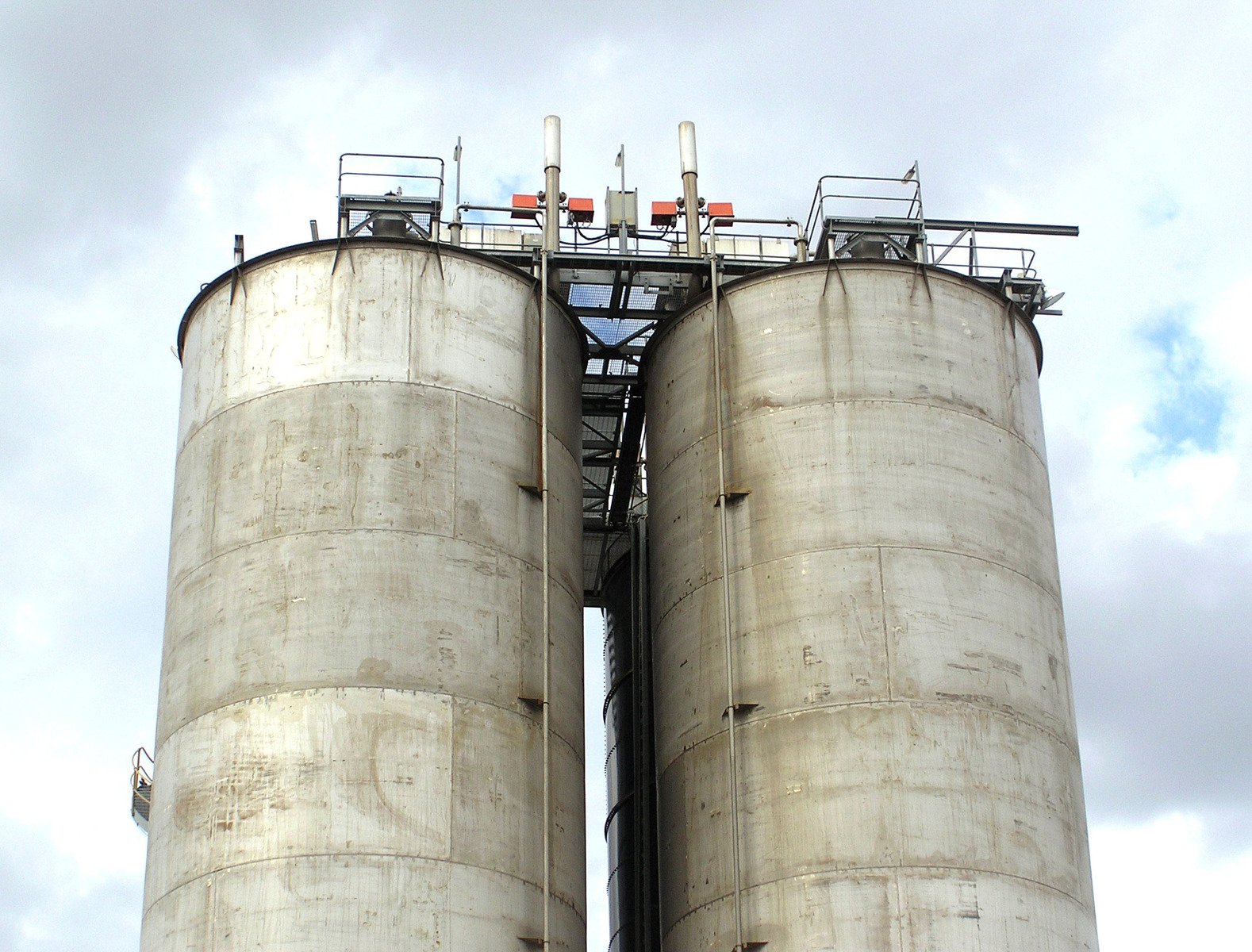 the industrial silos are all lined up for storage