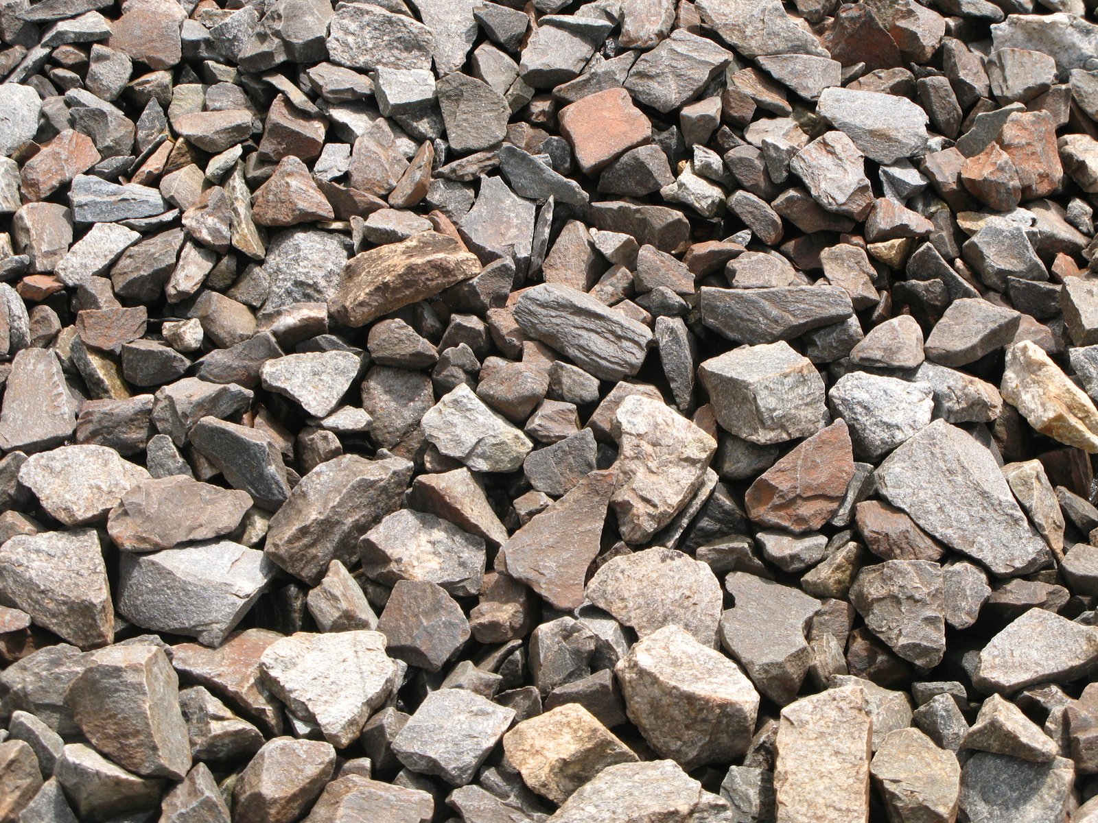 a pile of grey, red, and brown rocks