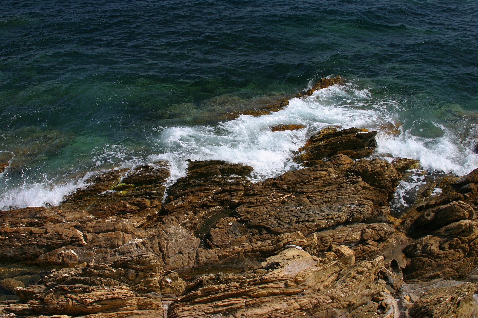 the view of an ocean with a rocky outcropping