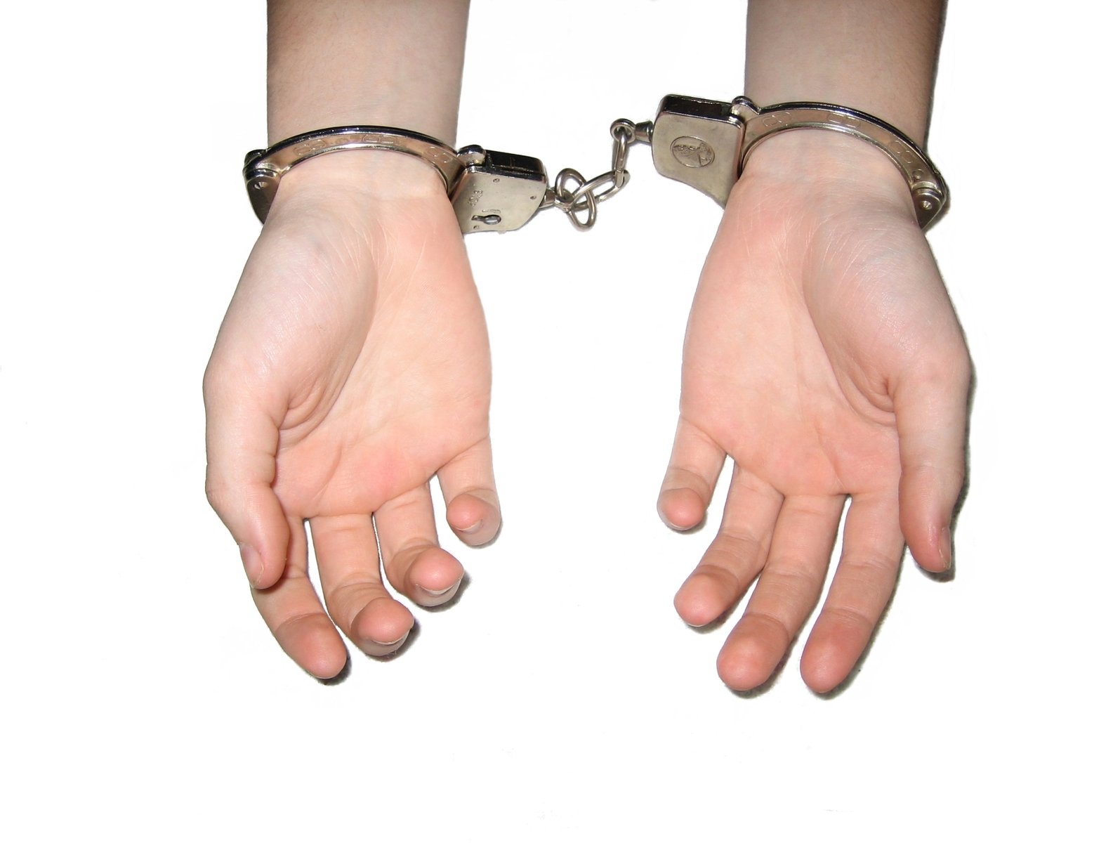 two hands, one holding a chain and two  to each other
