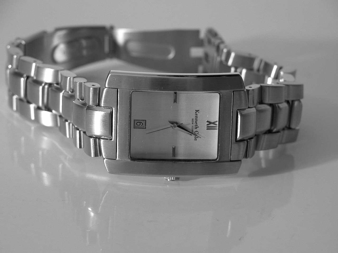 a watch is displayed on a counter with a light background