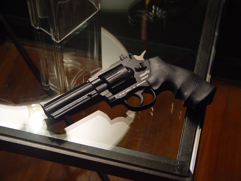 an automatic pistol on display on a table