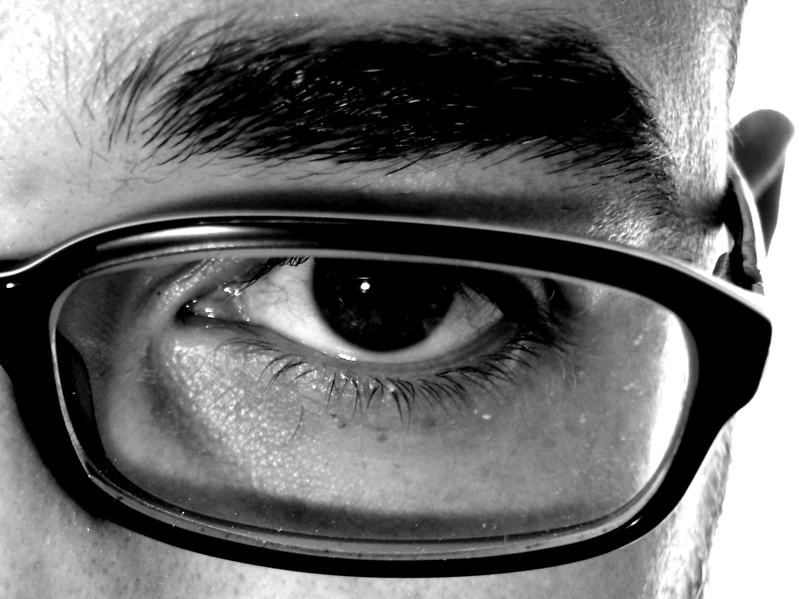 the side of a man's face wearing glasses