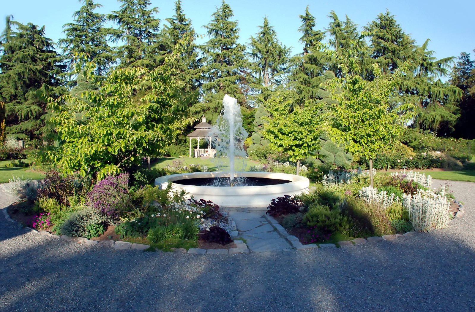 a garden with a fountain in the center