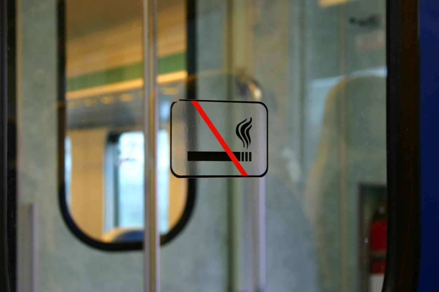 a white sign sitting on the side of a train door