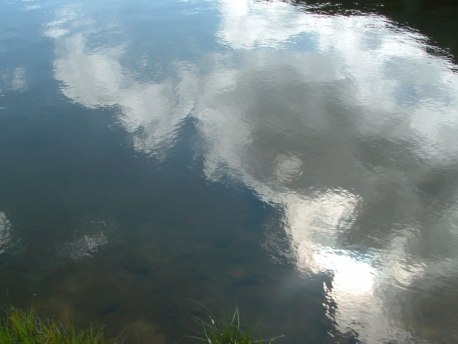 water and sky reflecting off the surface of a body of water