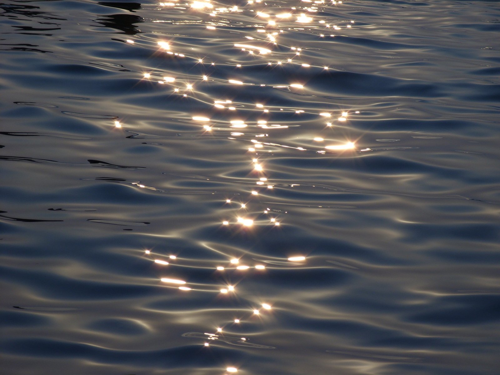 the sun reflecting off the water on the ocean