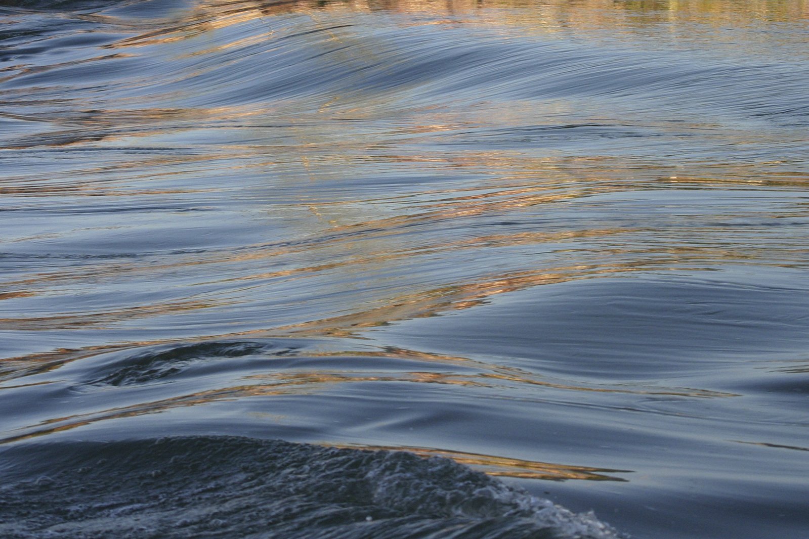 a body of water that is next to a hill