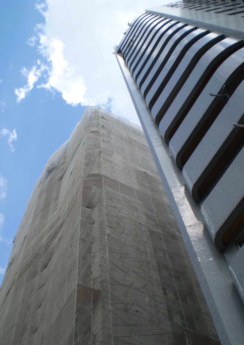 the top of a tall building and a taller tower