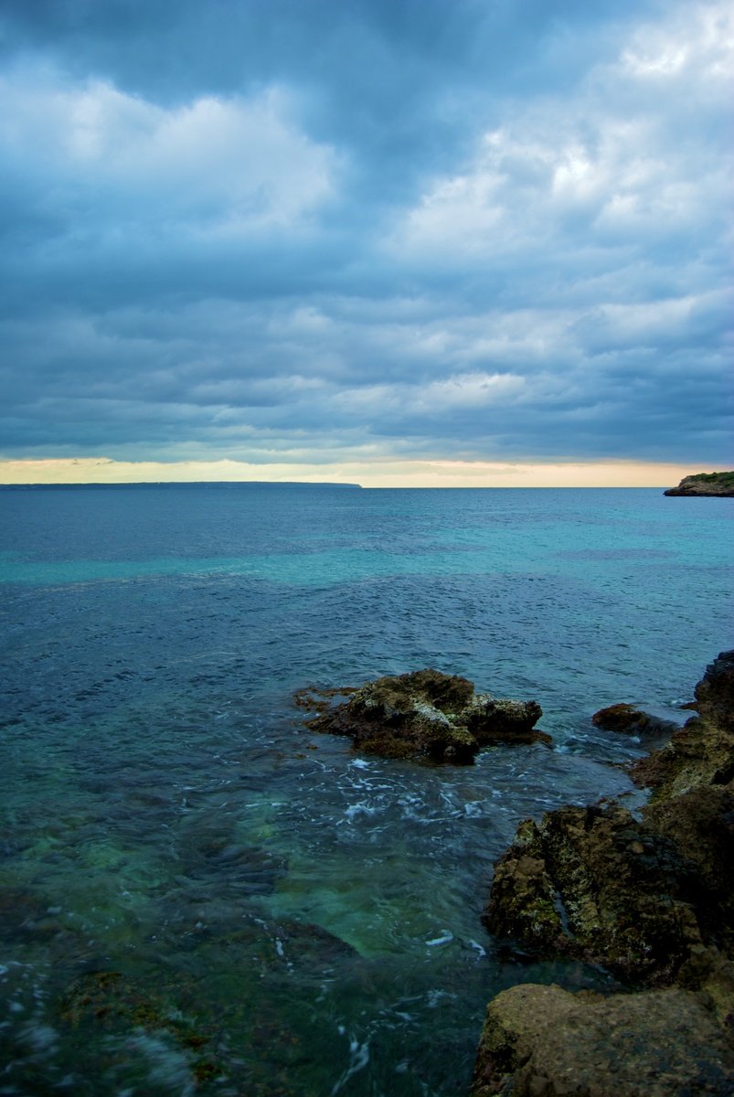 a lone boat sits out on the ocean