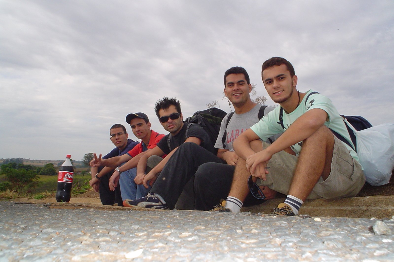 group of s on the ground next to a road