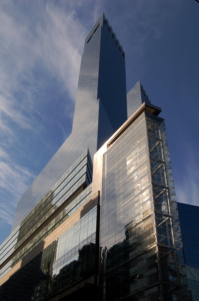 very tall glass and metal building against the blue sky