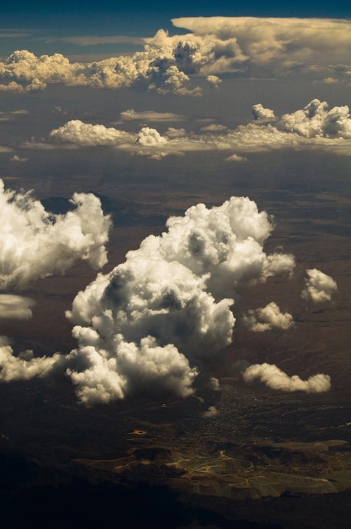 white puffy clouds against a blue sky