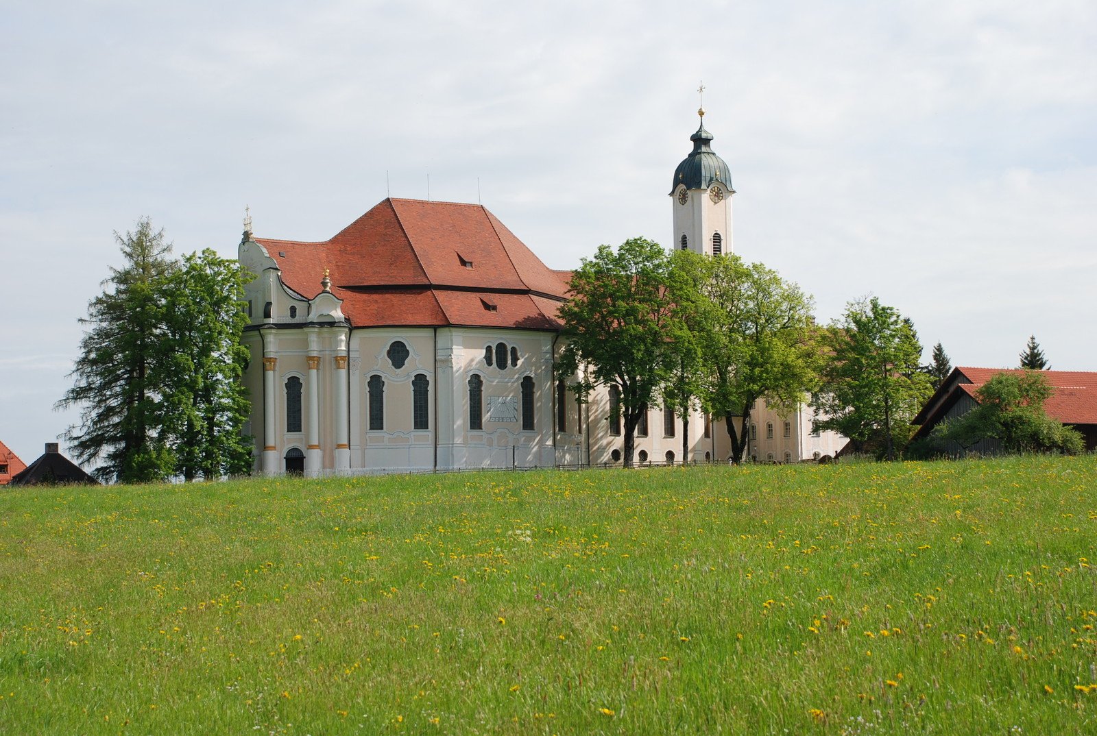 an old church building on the side of a hill