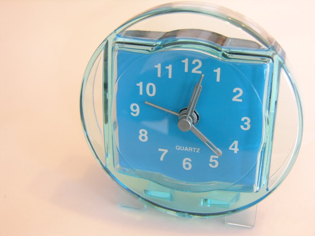 a large glass clock with an unusual shaped cover