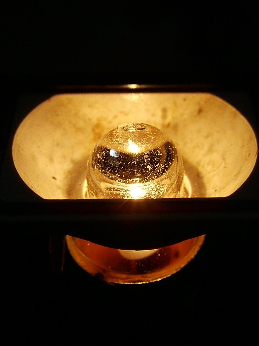 closeup of a shiny gold bell in the dark