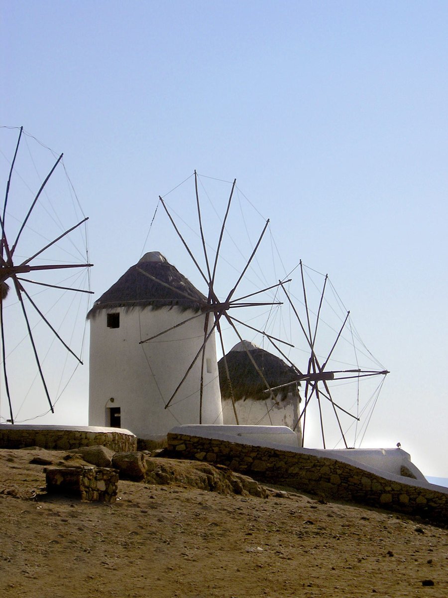 two windmills that are on a stone ledge