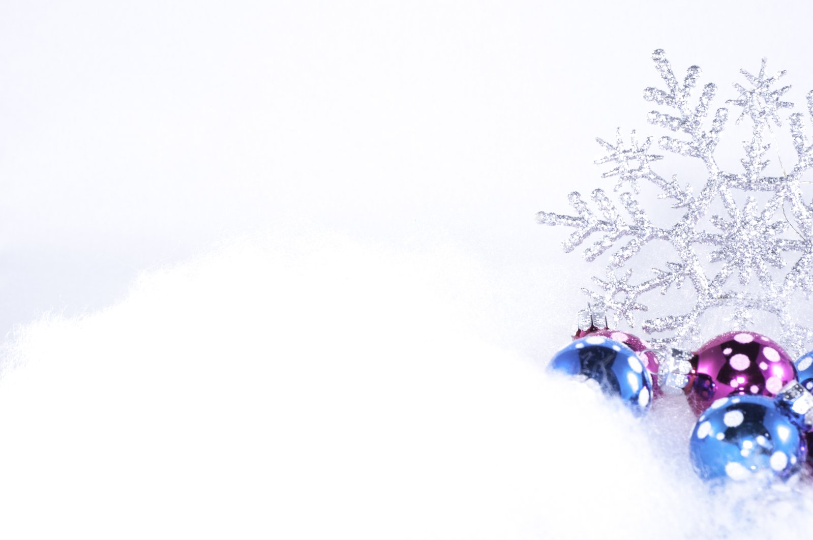 two blue and red ornament balls in the snow